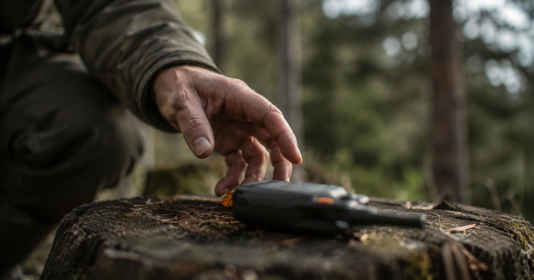 A set of two-way handheld radios and an emergency weather radio arranged on a wooden surface